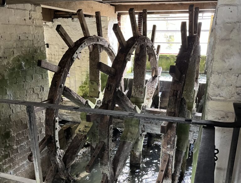 Wooden mill wheels with water splashing below