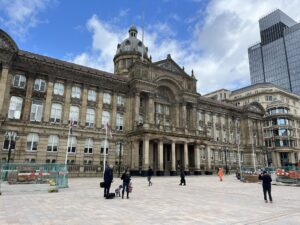 Imposing-looking building with pillars at the entrance and a domed tower above.