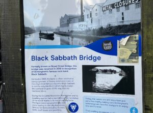 Information board by the canal. The first paragraph reads: "Formally known as Broad Street Bridge, this bridge was renamed in 2019 in recognition of Birmingham's famous rock band, Black Sabbath."