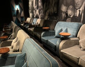 Plush cinema seats in grey and turquoise.